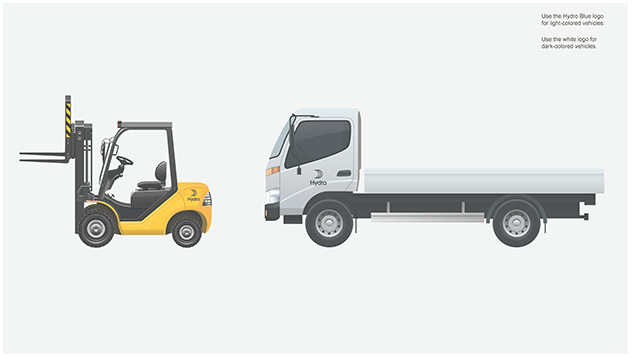 yellow forklift with small dark logo above rear wheels, lorry with logo centered on cab door.