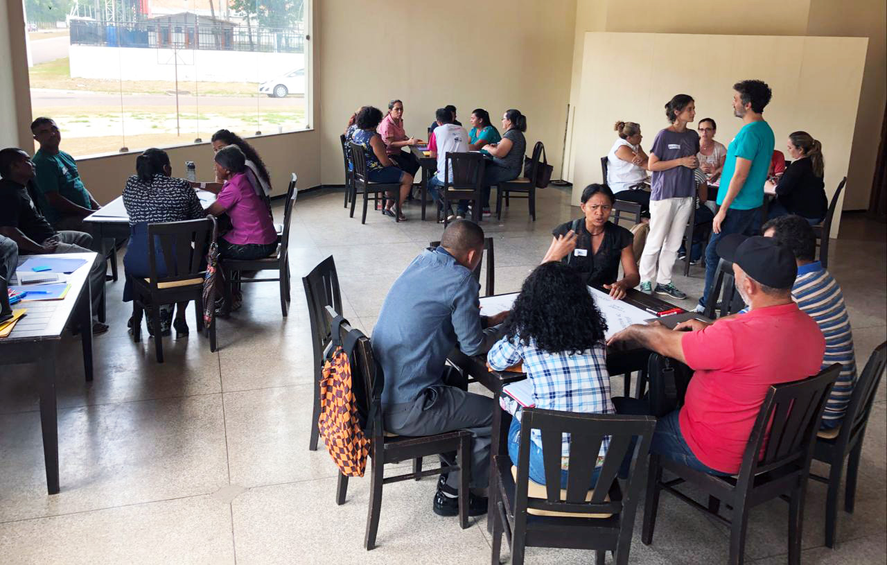 People sitting around tables in discussions