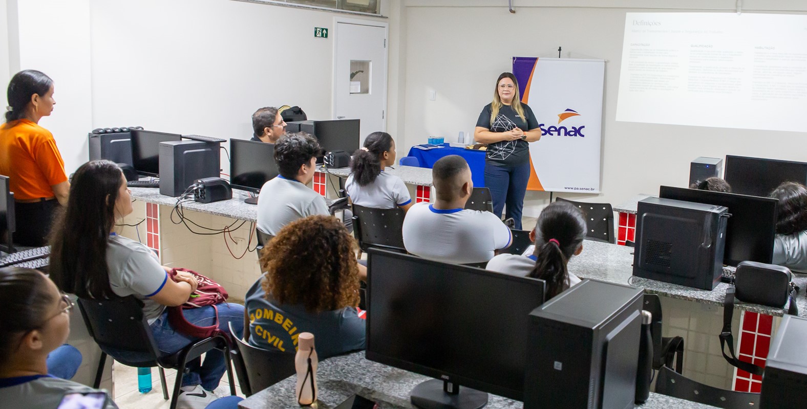 a group of people sitting at computers