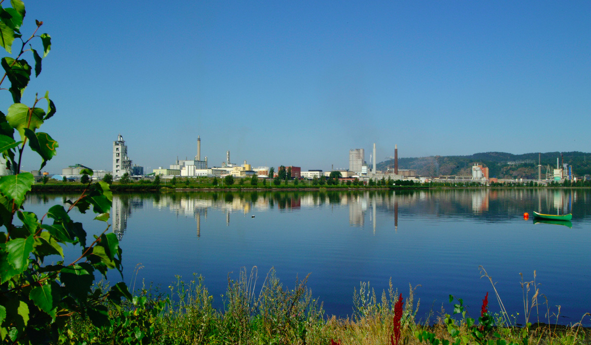 a body of water with a city in the background