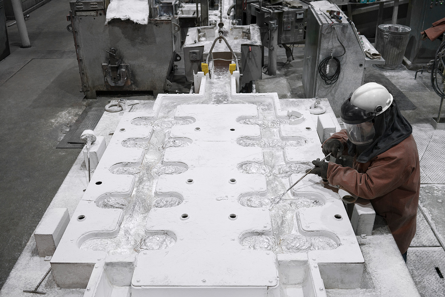 a person in a helmet working on a sculpture