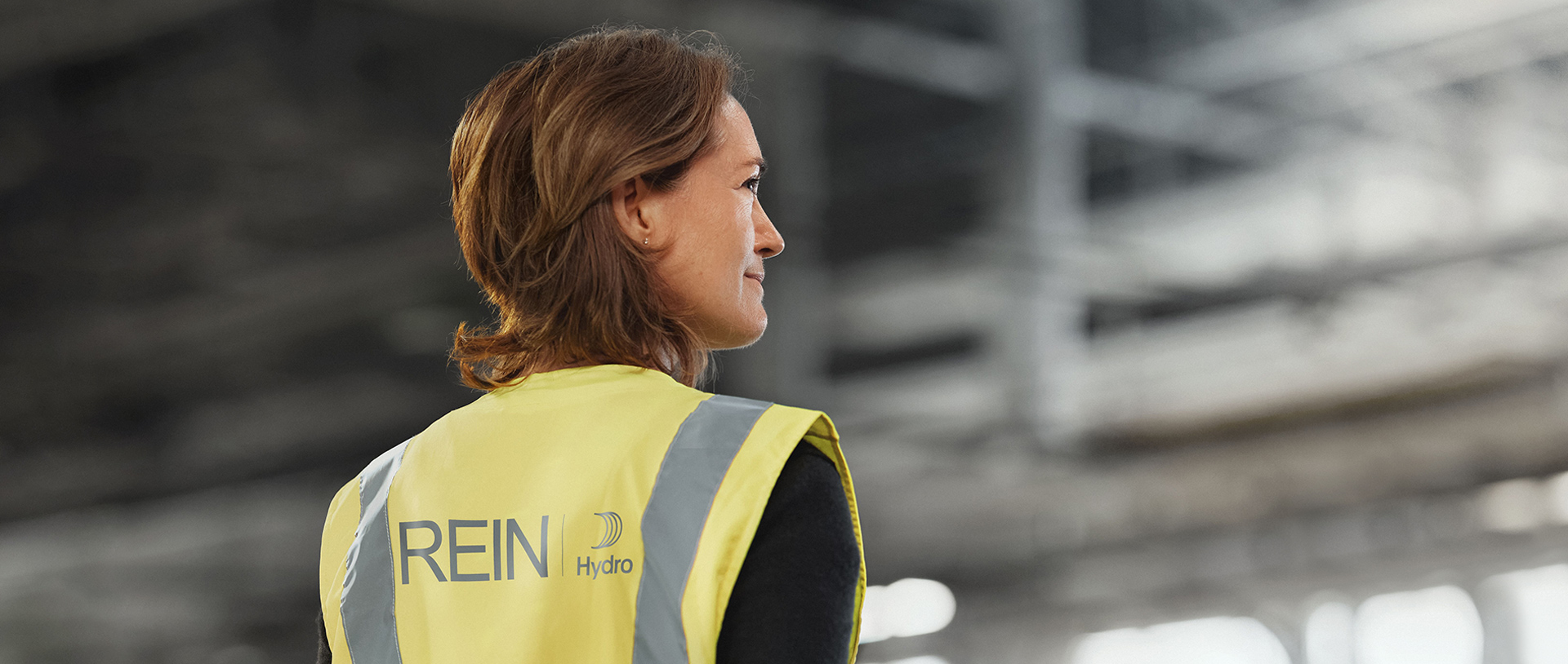 Woman wearing a high-visibility vest with Hydro Rein logo
