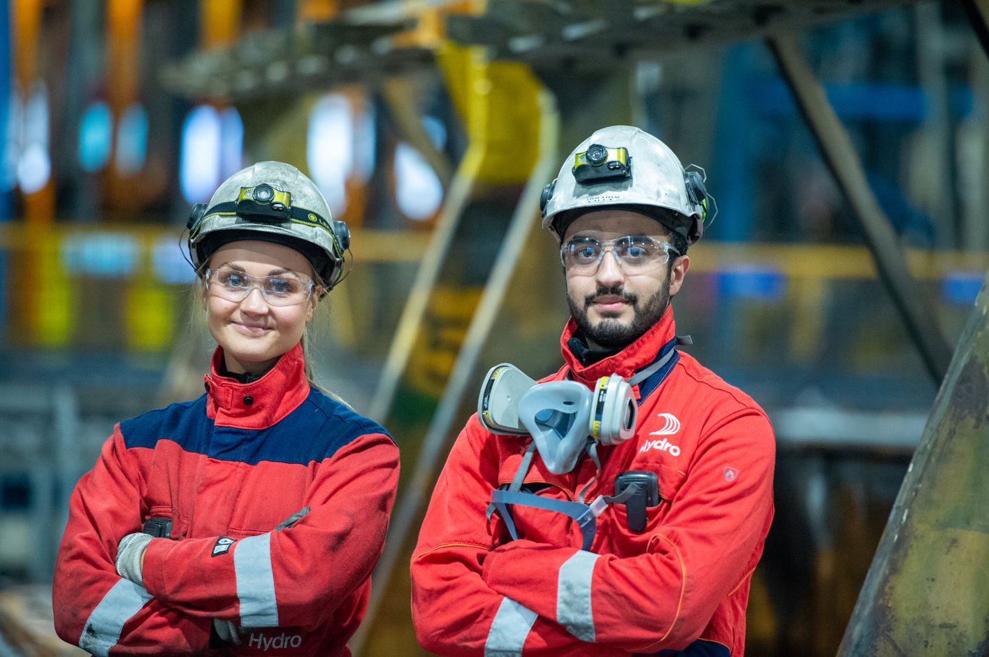 a man and woman wearing helmets and harnesses